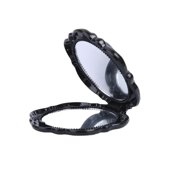 Handheld foldable pocket mirror showing open, double-sided feature.